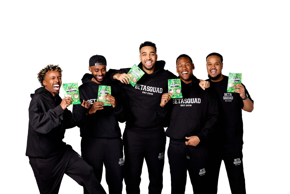 The Beta Squad holding packs of Shades The Beta Five